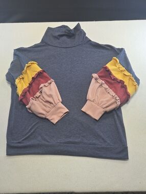 Raw Edge Turtleneck Top with Colorblock Ruffle Sleeves